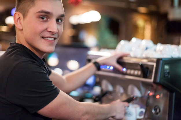 Free Photo smiling barista brewing coffee