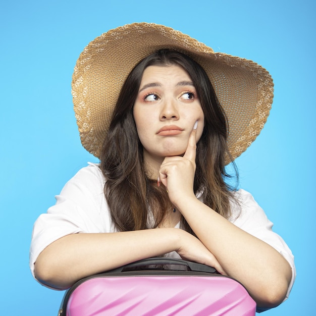 Smiling beautiful girl in hat goes on holiday wants to rest