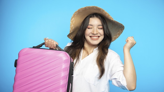 Smiling beautiful girl in hat goes on holiday wants to rest