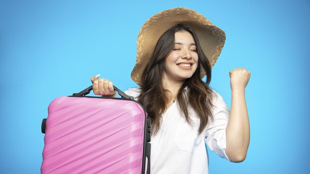 Smiling beautiful girl in hat goes on holiday wants to rest