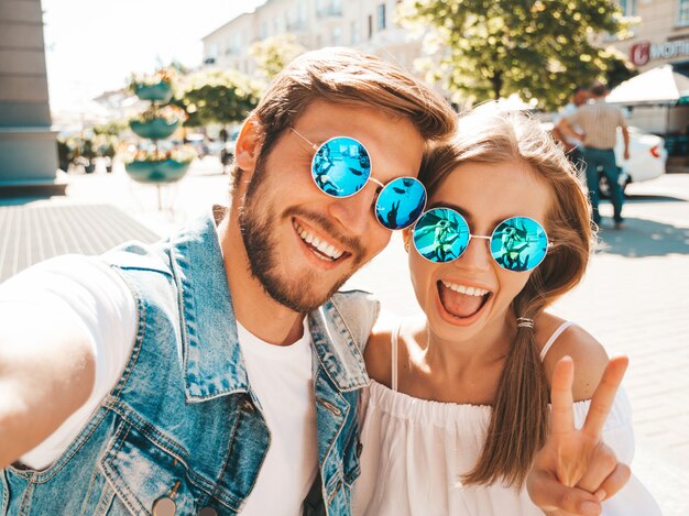 Smiling beautiful girl and her handsome boyfriend in casual summer clothes.