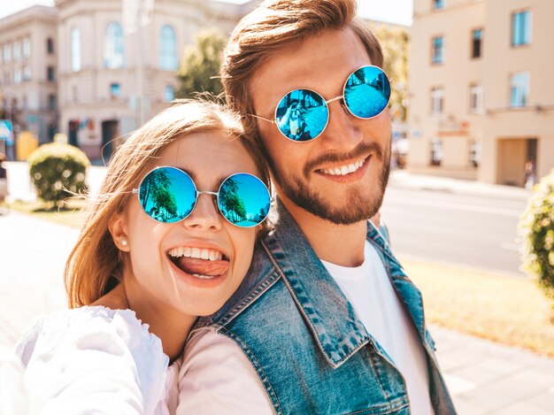 Smiling beautiful girl and her handsome boyfriend in casual summer clothes.