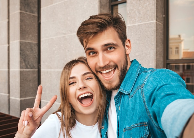 Smiling beautiful girl and her handsome boyfriend in casual summer clothes. 