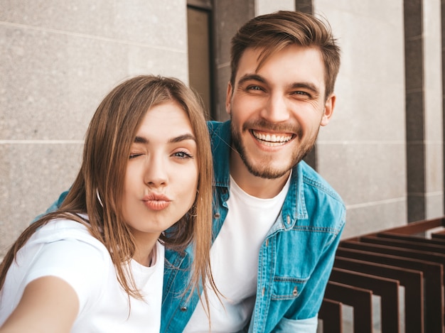 Smiling beautiful girl and her handsome boyfriend in casual summer clothes. 