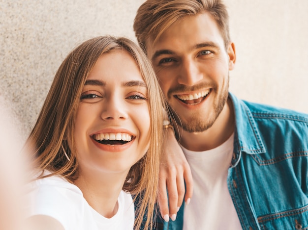 Smiling beautiful girl and her handsome boyfriend in casual summer clothes. 