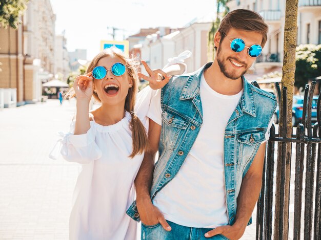 Smiling beautiful girl and her handsome boyfriend walking in the street. 