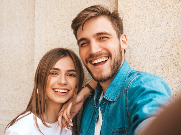 Smiling beautiful woman and her handsome boyfriend in casual summer clothes. 