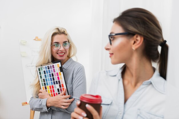 Smiling beautiful women looking at each other