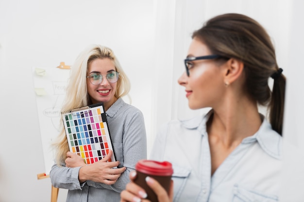 Smiling beautiful women looking at each other