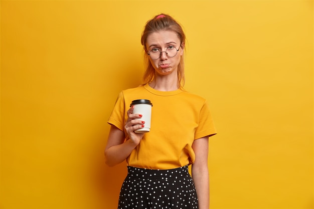 Free Photo smiling beautiful young woman frowns eyebrows and keeps lips folded