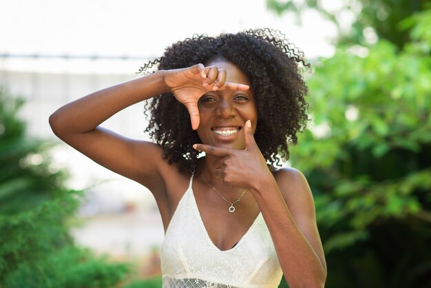 Smiling Black Woman Making Frame Gesture