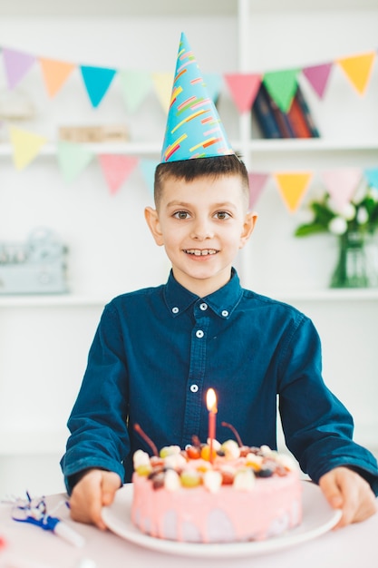 Free Photo smiling boy with a birthday cake