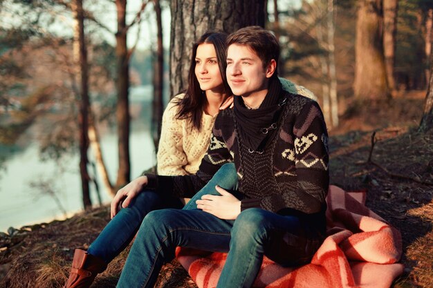 Smiling boyfriend touching his girlfriend's knee