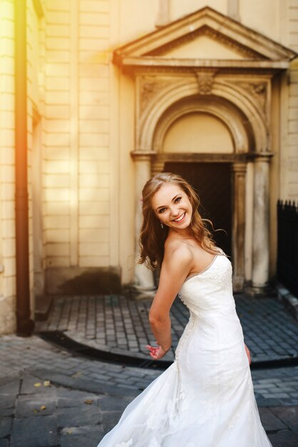 Smiling bride with arms on back