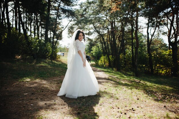 Smiling brunette bride standing outdoors