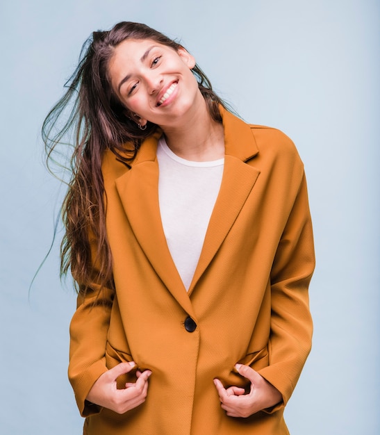 Free Photo smiling brunette girl posing with coat