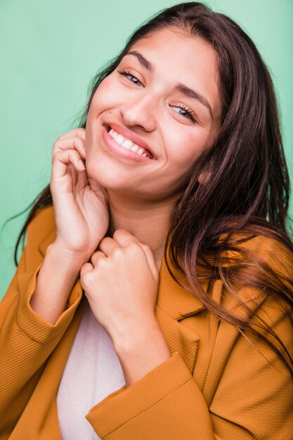 Smiling brunette girl posing with coat