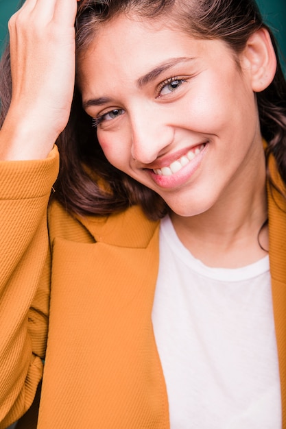 Free photo smiling brunette girl posing with coat