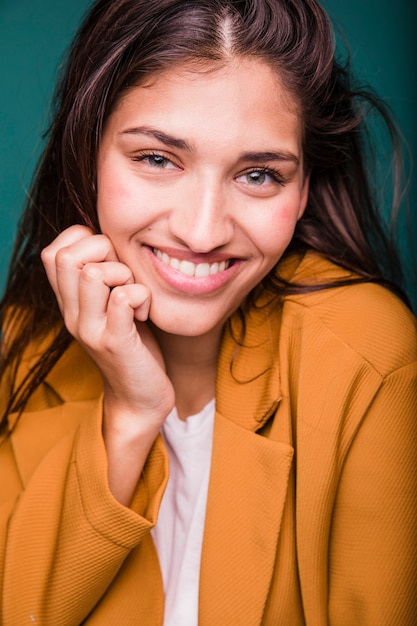 Free photo smiling brunette girl posing with coat