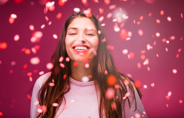 Smiling brunette girl with confetti