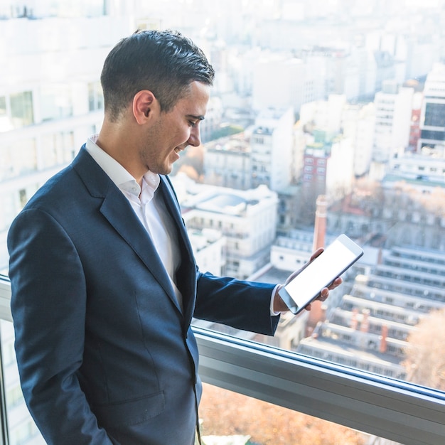 Smiling businessman looking at smartphone