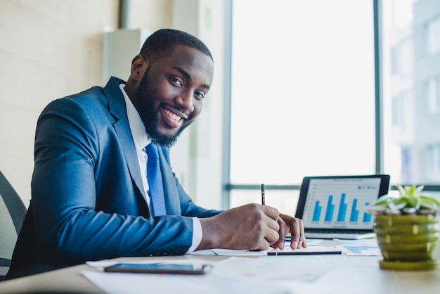 Smiling businessman signing contract