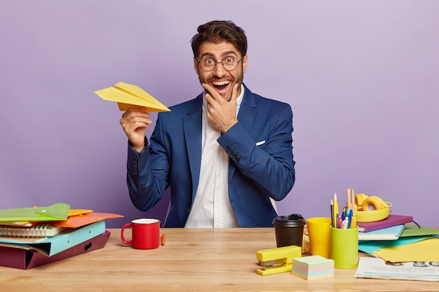 Smiling businessman sitting at the office desk