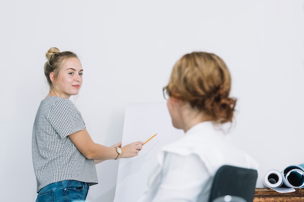 Free Photo smiling businesswoman explaining new business plan to her colleague