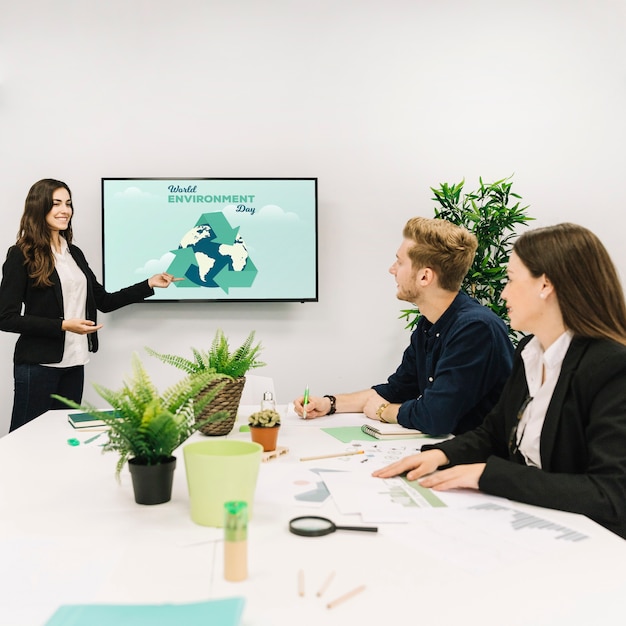 Smiling businesswoman giving presentation on world environment day to hr colleagues