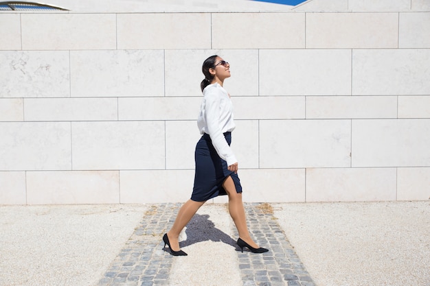 Free Photo smiling businesswoman on her way to office