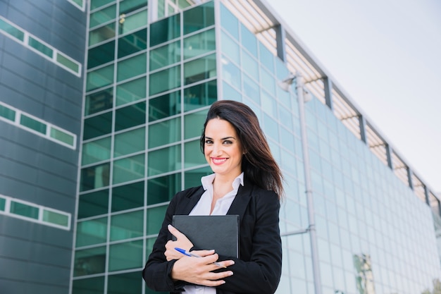 Smiling businesswoman with folder