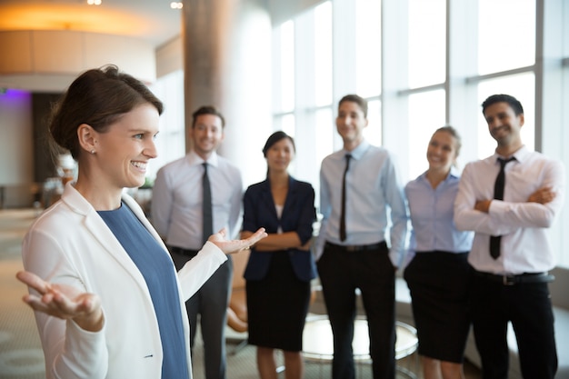 Free Photo smiling businesswoman with team