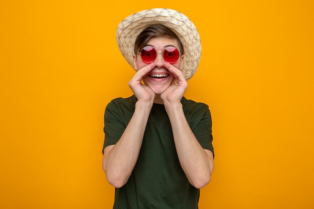 Smiling calling someone young handsome guy wearing hat with glasses 