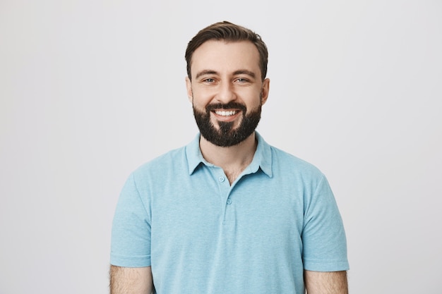 Smiling caucasian guy with beard looking happy