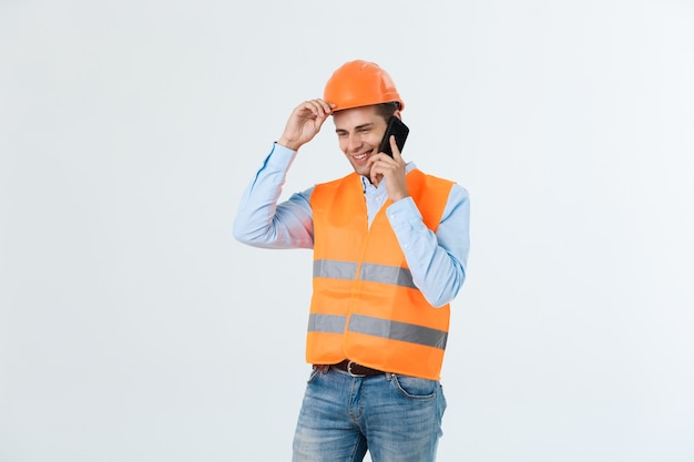 Free photo smiling construction engineer posing isolated over grey background.