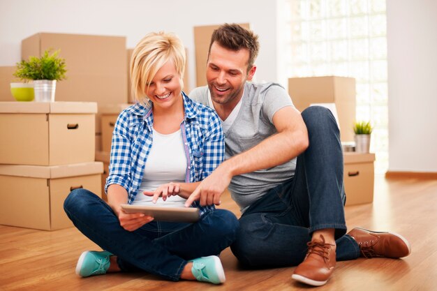 Smiling couple buying new furniture for their home