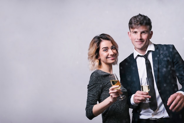 Smiling couple holding glasses of champagne