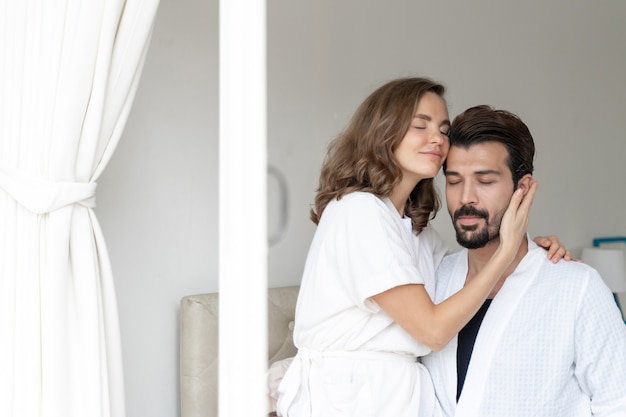 smiling couple relaxing and Couples cuddling in bed