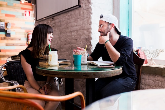 Smiling couple sitting together in the cafe