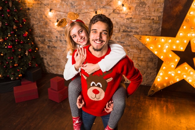 Smiling couple standing in front of christmas star decoration