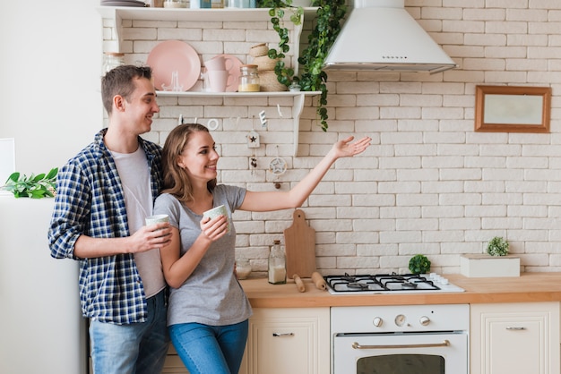 Smiling couple standing together in kitchen