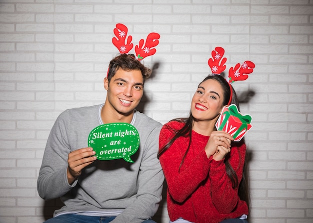 Smiling couple with Christmas decorations 