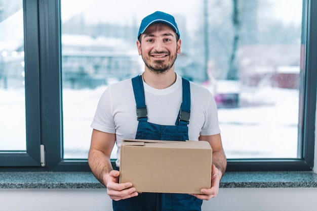 Smiling courier with parcel