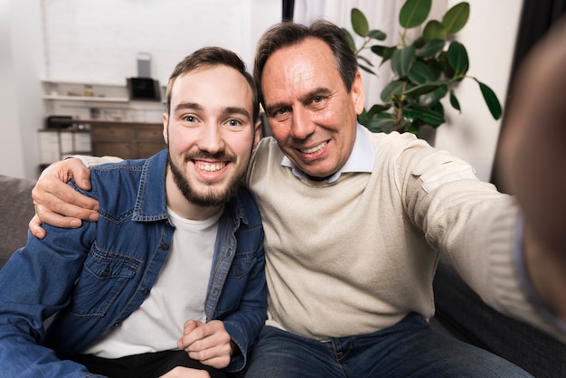 Smiling father and son taking a selfie