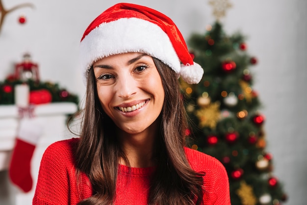 Smiling female in Christmas hat 