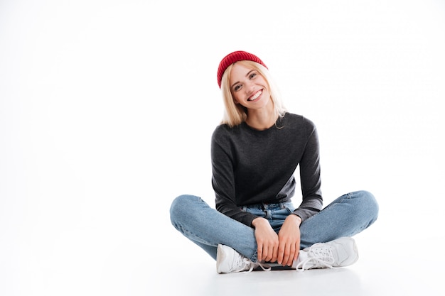 Free Photo smiling female hipster sitting on the floor