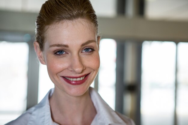 Smiling female staff at airport terminal