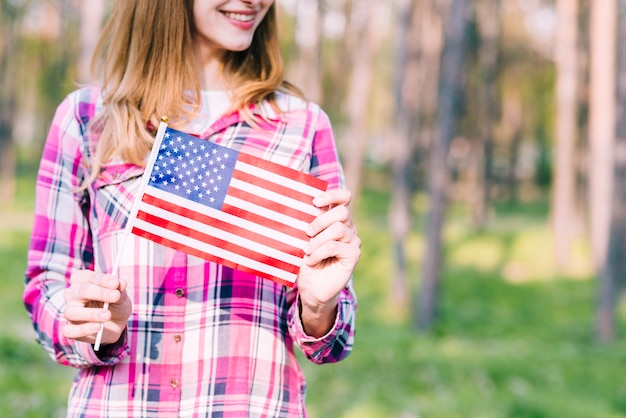 Free photo smiling female with american flag in hands