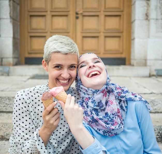 Smiling friends eating ice cream