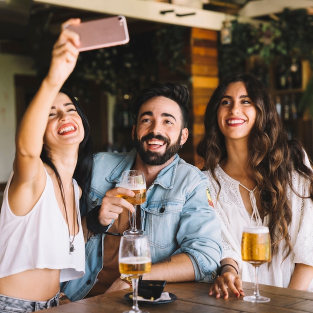 Smiling friends taking selfie